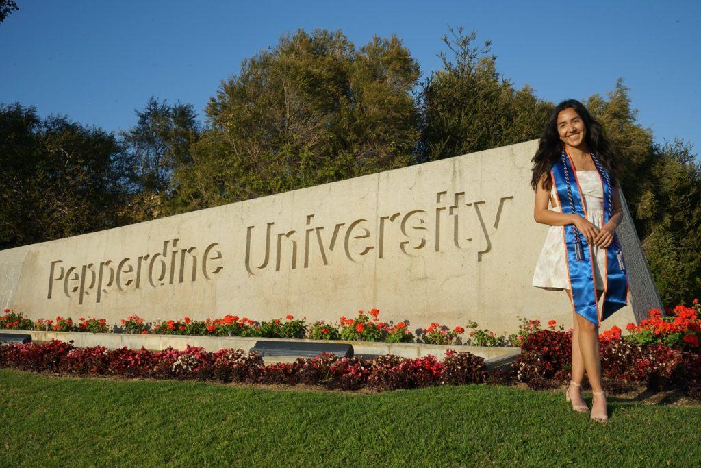 Managing Editor Gabrielle Salgado poses in front of Pepperdine's campus with her graduation regalia March 23. As graduation approaches, it is important to remember to slow down. Photo courtesy of Gabrielle Salgado